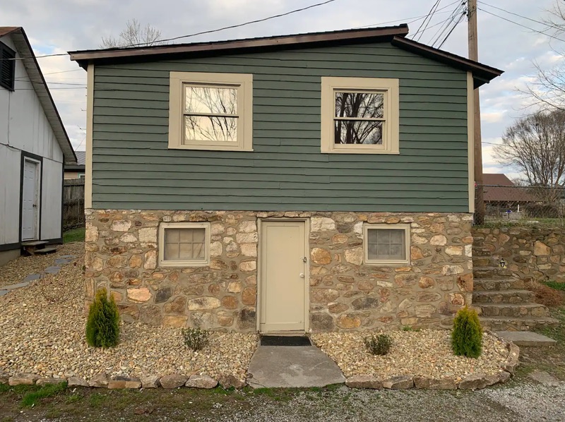 Cottage Two exterior with stone foundation and covered porch