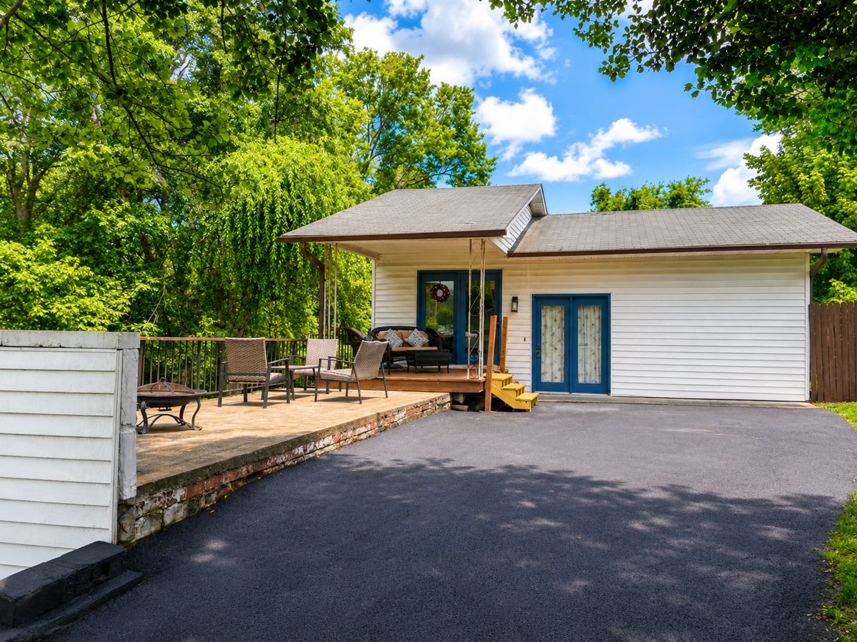 RiverView cottage exterior with covered porch and blue doors